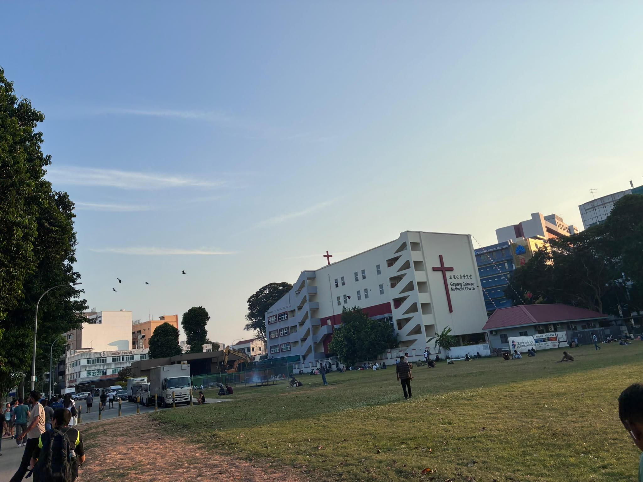 Geylang Chinese Methodist Church seen across an open field at dusk