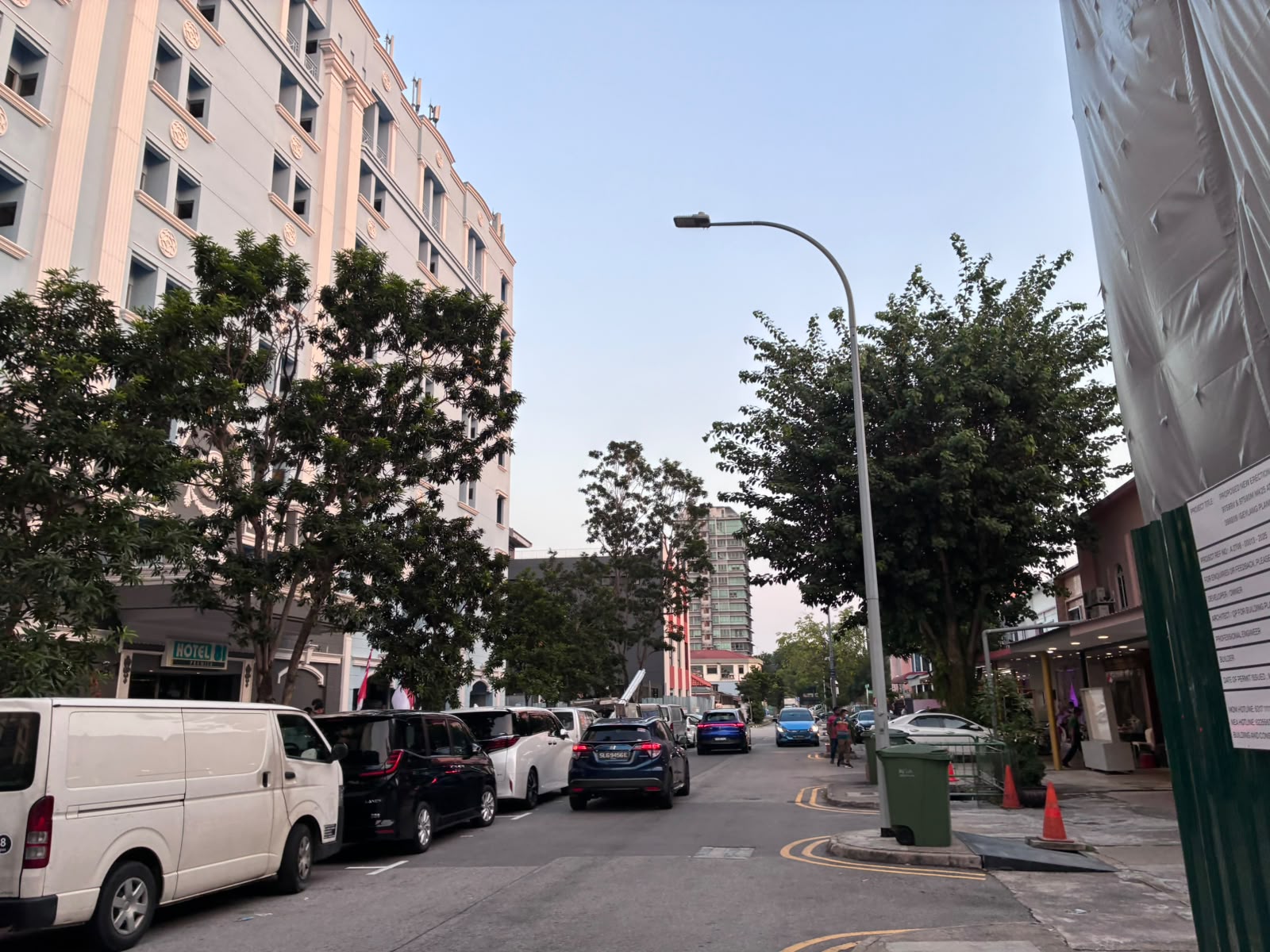 Row of budget hotels along a Geylang lorong at dusk