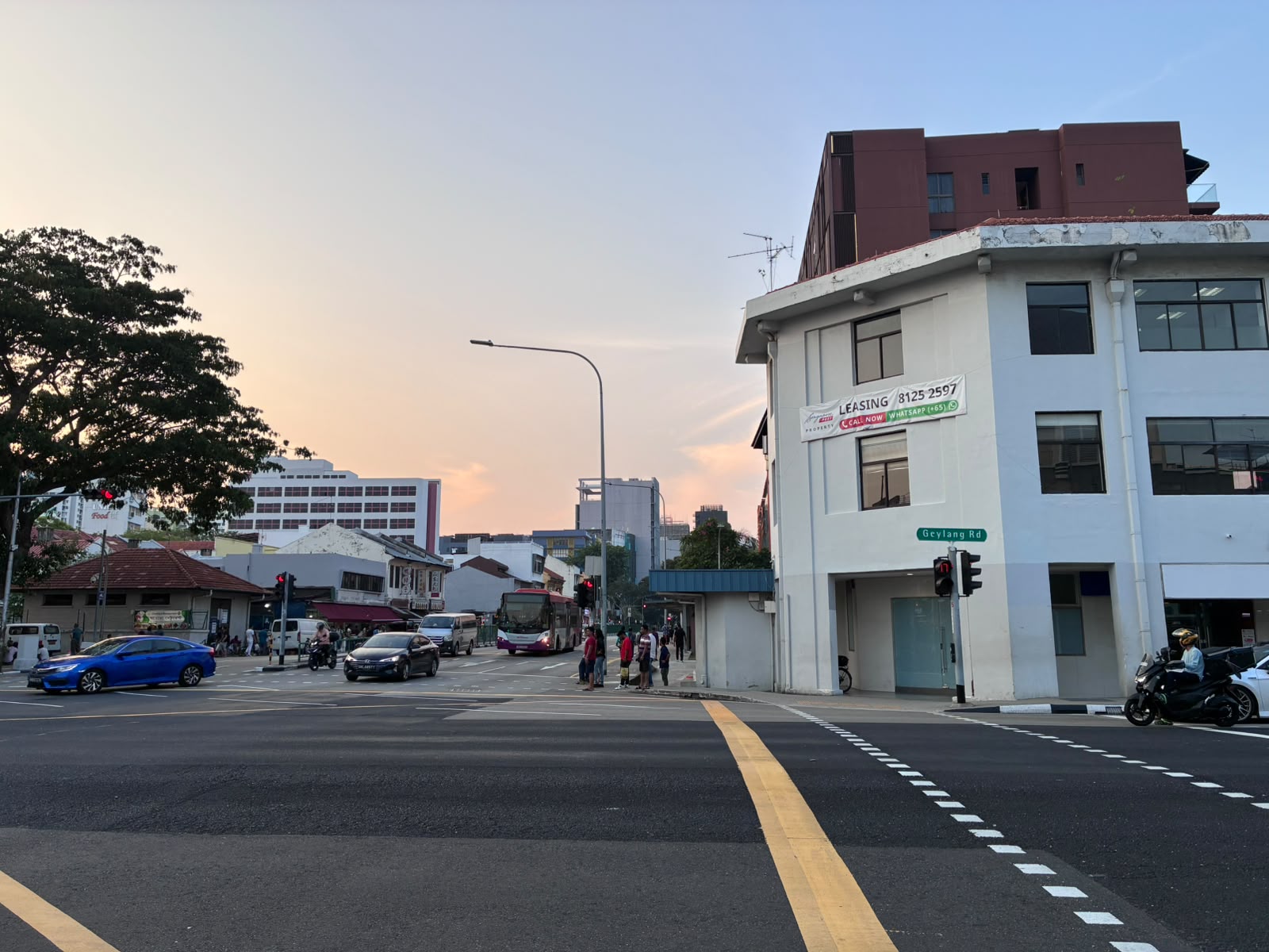 Geylang Road street sign at a junction in the evening