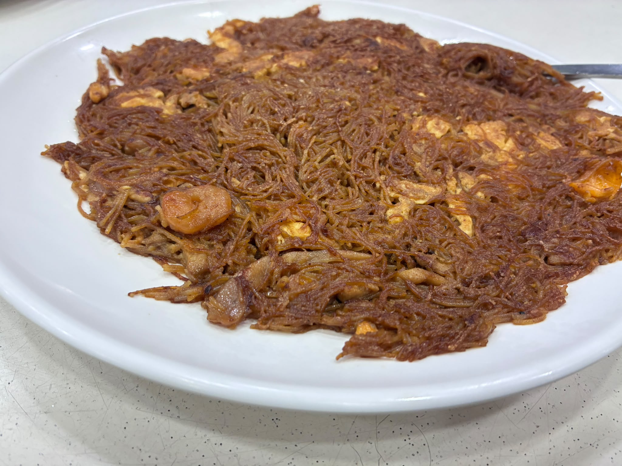 Close-up side view of crispy fried bee hoon with prawns