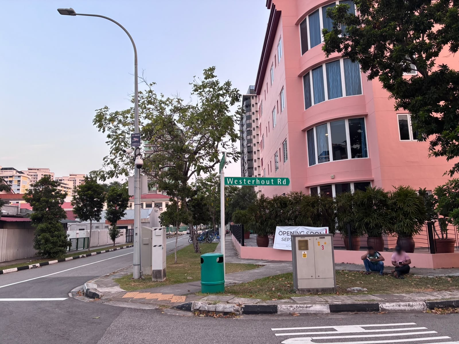 Pink-painted building at the corner of Westerhout Road in Geylang (faces blurred)