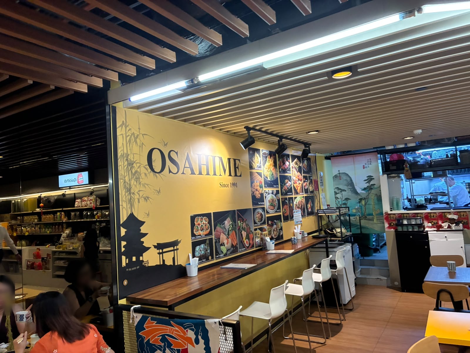 Osahime Japanese food stall with counter seating at The Basement, Singapore (faces blurred)