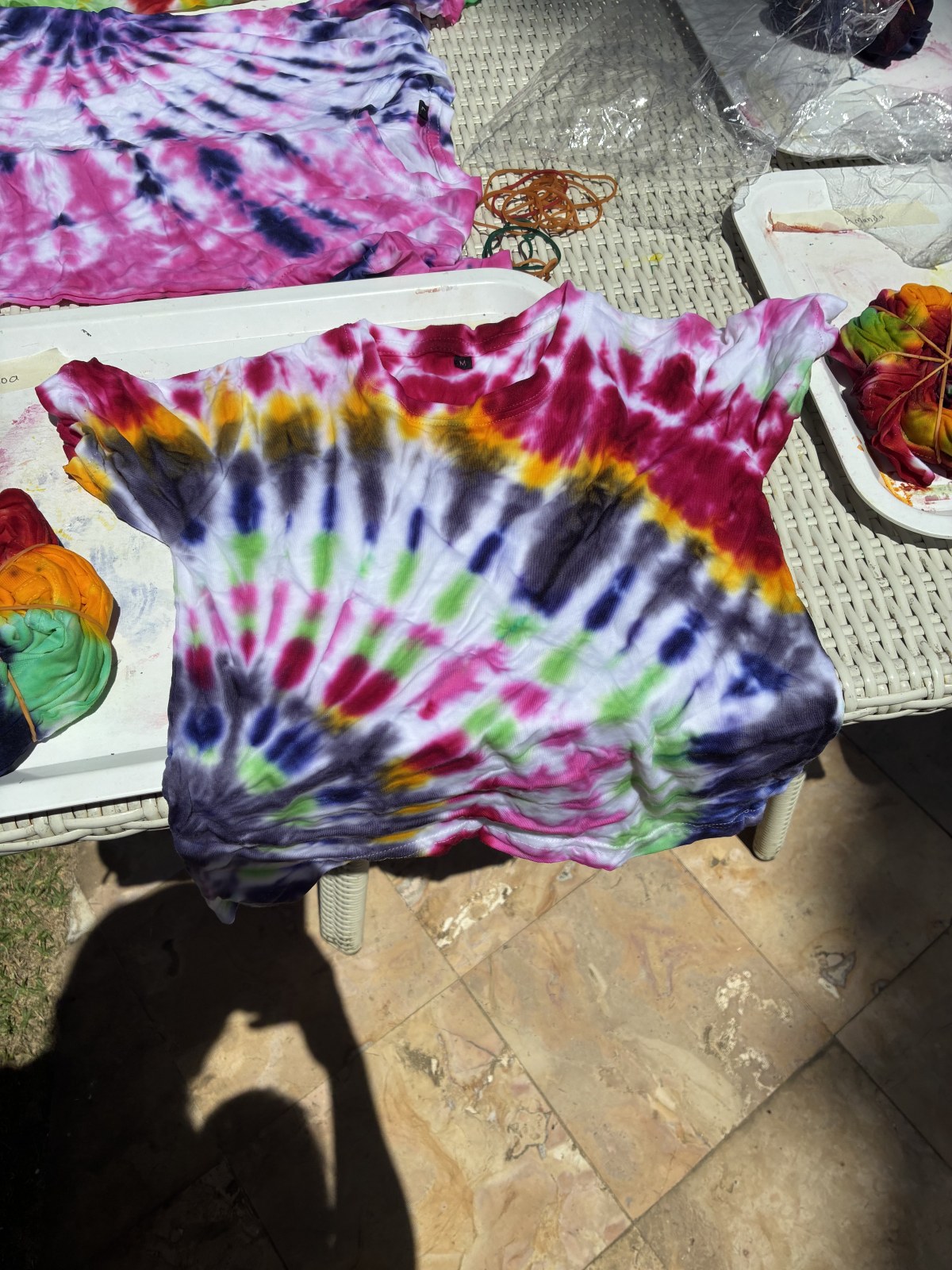 Finished tie-dye shirt with rainbow pattern drying at a workshop in Bali, Indonesia