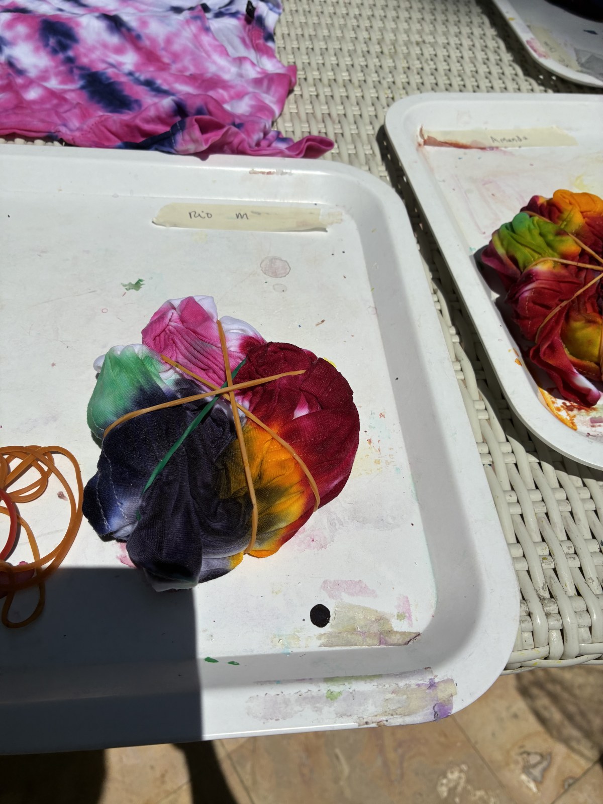 Tie-dye workshop tray with a shirt bound with rubber bands and dye applied, Bali, Indonesia