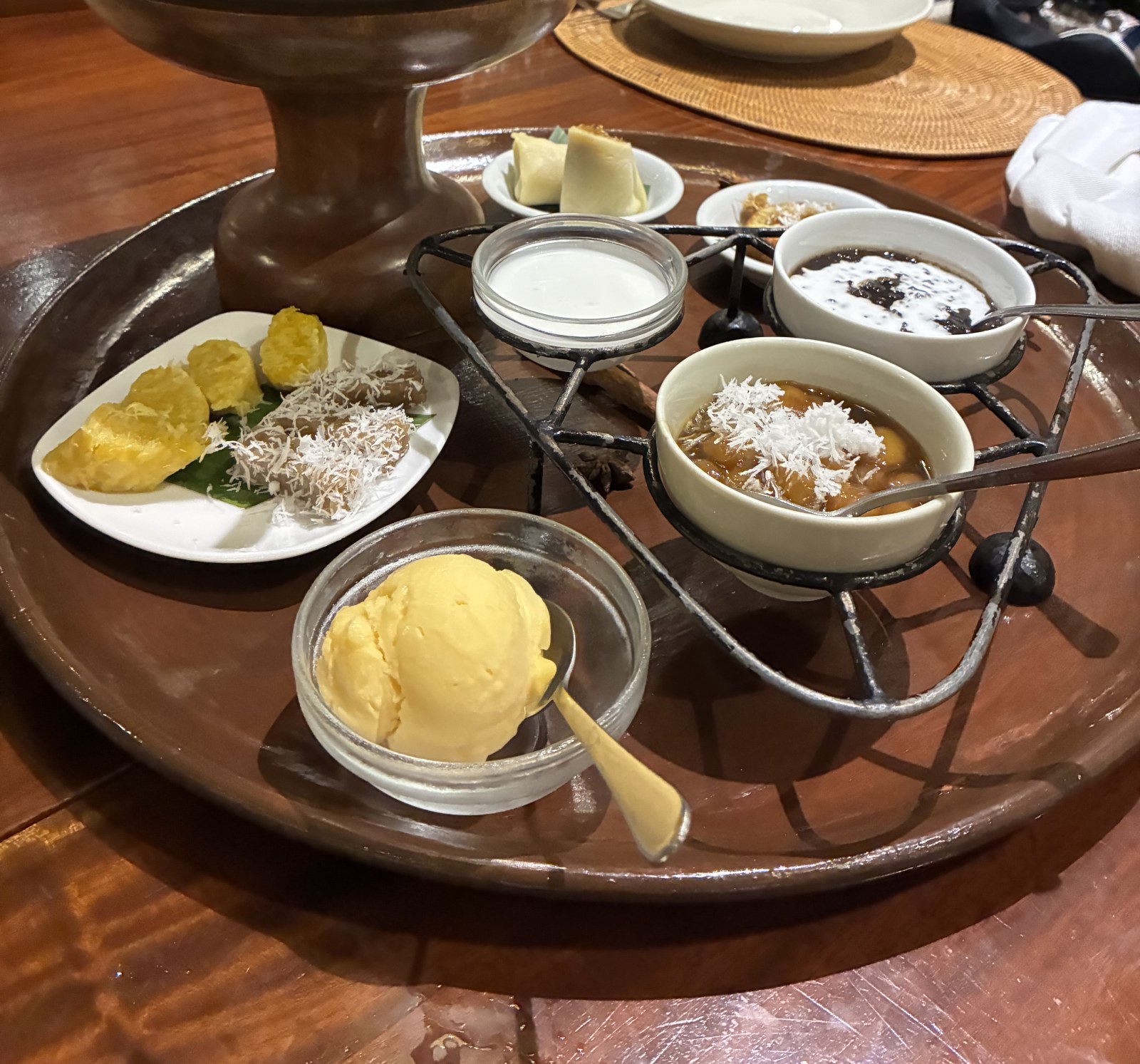 Balinese dessert platter with black rice pudding, coconut, banana fritters and ice cream, Indonesia