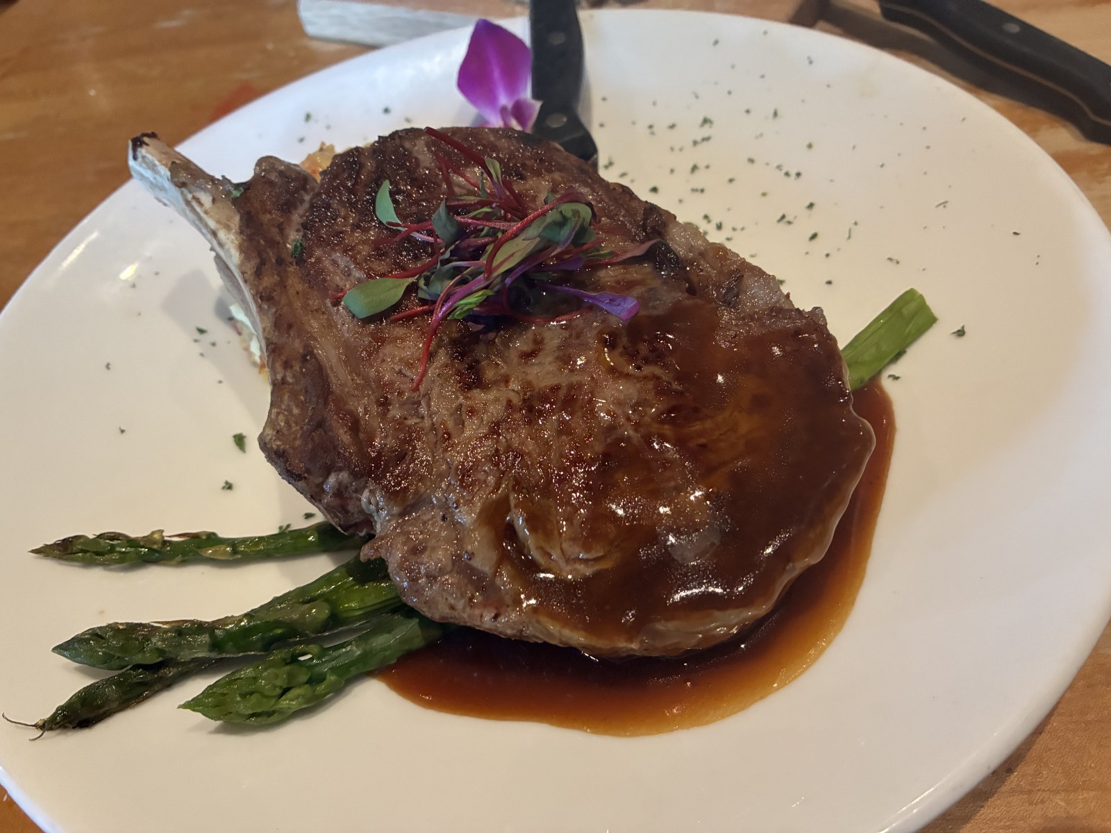 Bone-in ribeye steak with asparagus at Market Broiler, Ontario Mills, California