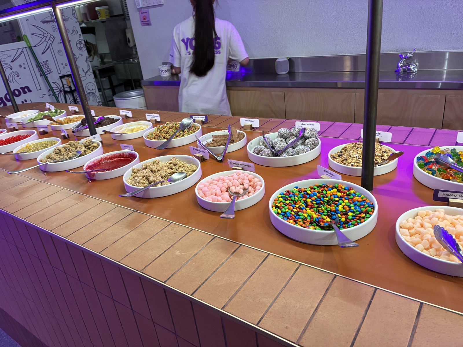 Self-serve frozen yogurt topping bar in central Cairns at night