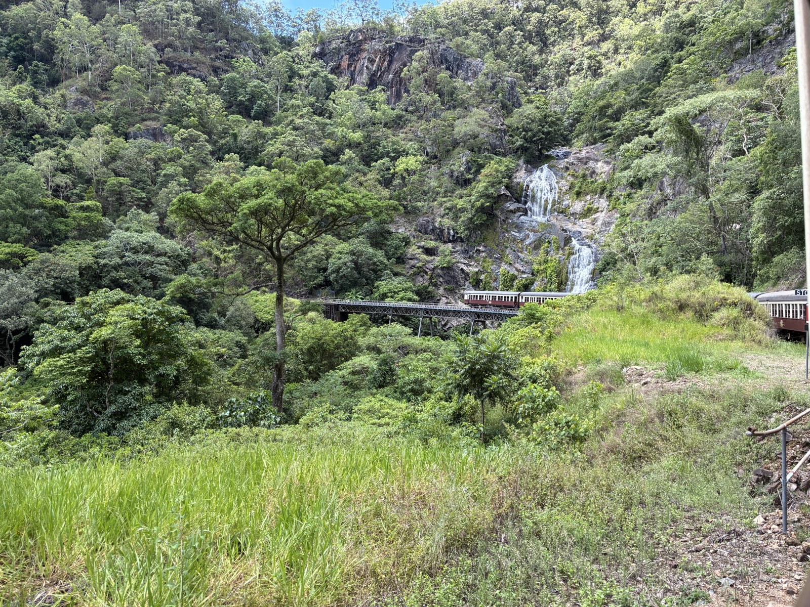 Stoney Creek Falls and the Kuranda Scenic Railway bridge seen from the train