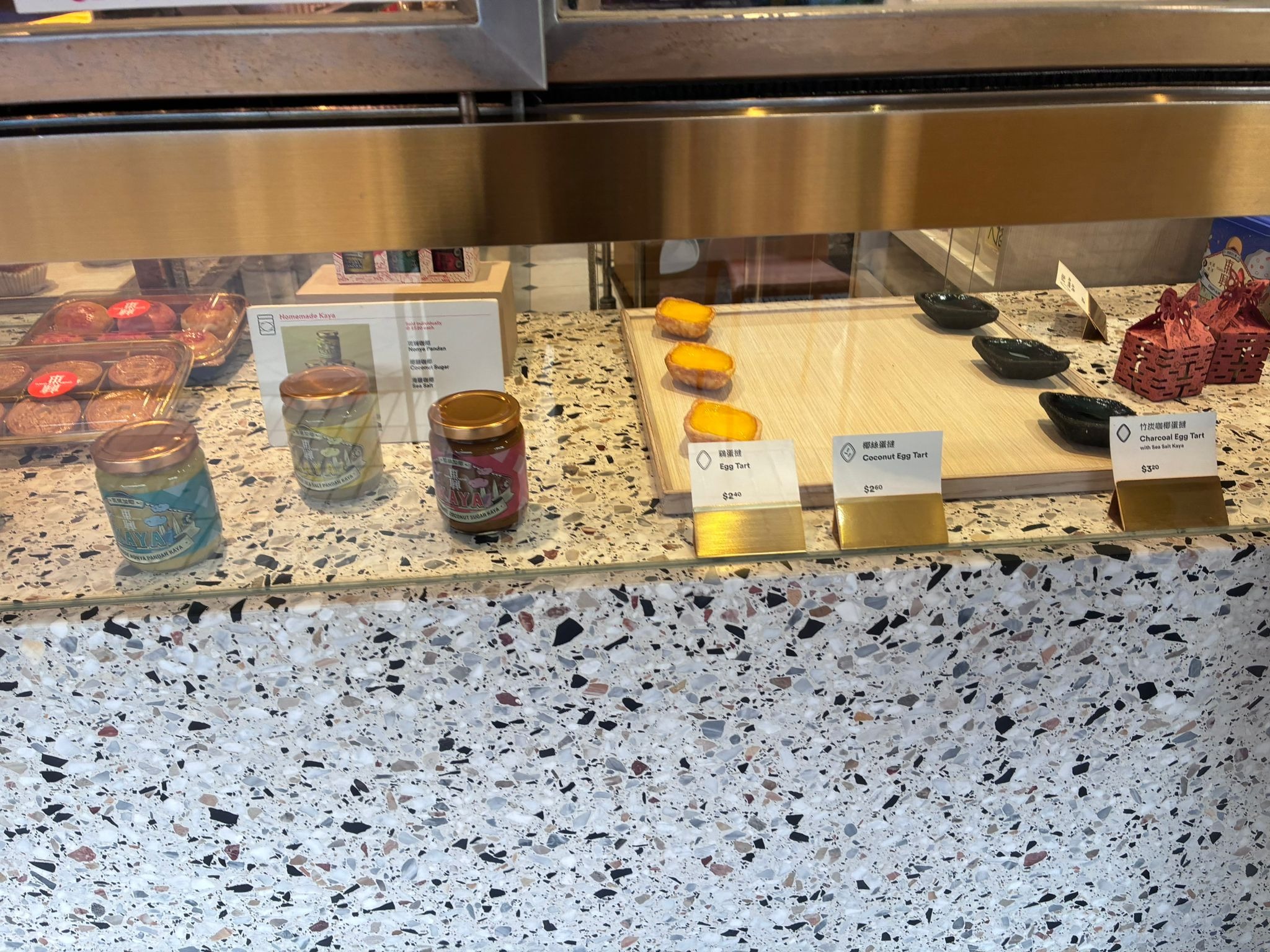 Tong Heng egg tarts with price tags and homemade kaya jars, Singapore