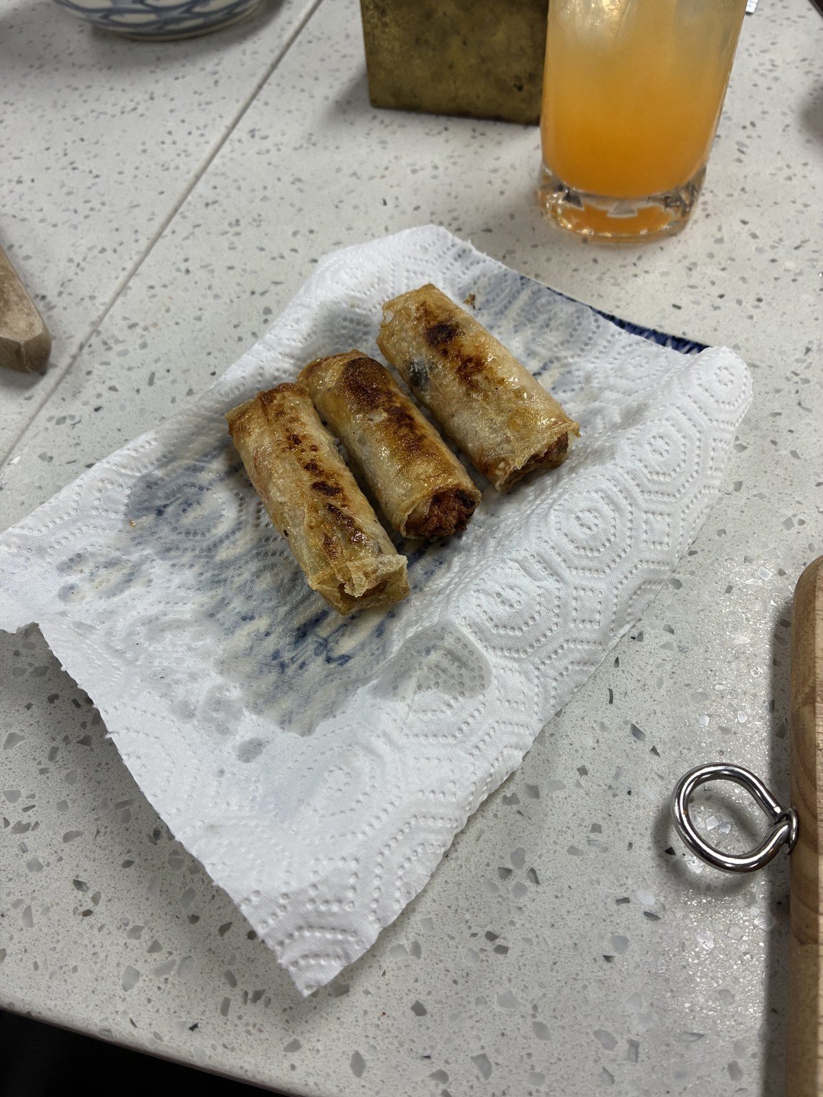 Three fried Vietnamese spring rolls draining on kitchen paper, Ho Chi Minh City