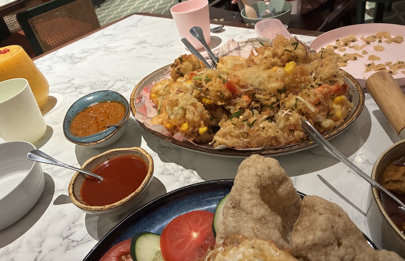 Deep-fried calamari with corn and herbs on a patterned plate at De.Wan 1958, Kuala Lumpur