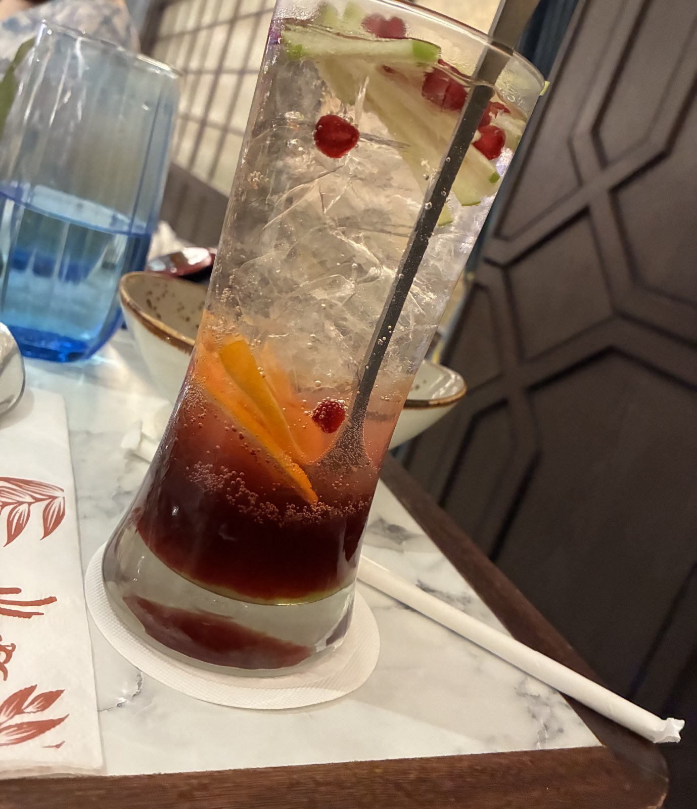 Tall glass of layered fruit soda with orange, apple and berries at De.Wan 1958, Kuala Lumpur