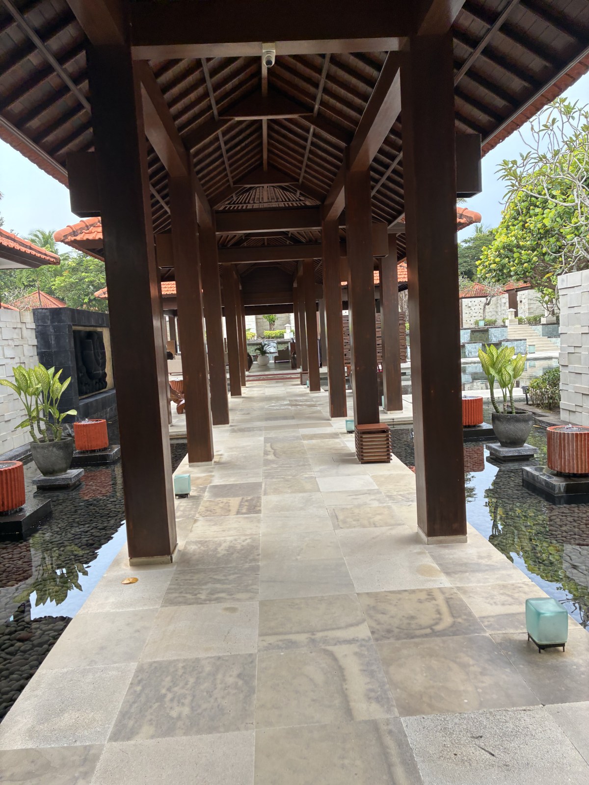 Wooden colonnade walkway over a lotus pond at Grand Hyatt Bali, Nusa Dua, Indonesia
