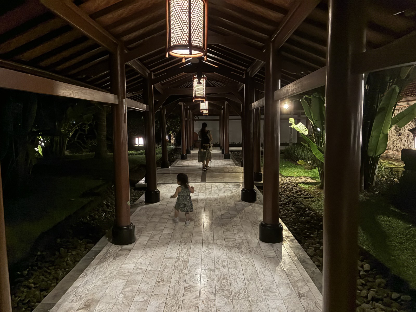 Covered garden walkway lit by lanterns at night at Grand Hyatt Bali, Nusa Dua, Indonesia
