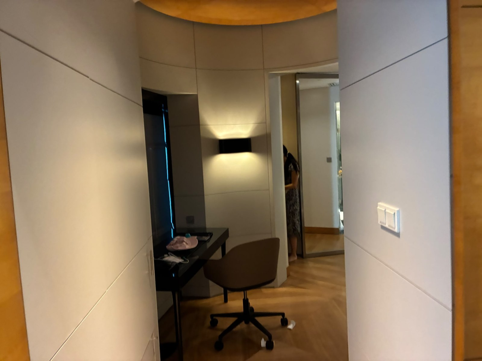 Writing desk between the living room and the bedroom of a Grand Executive Suite at Hilton Kuala Lumpur, Malaysia (faces blurred)