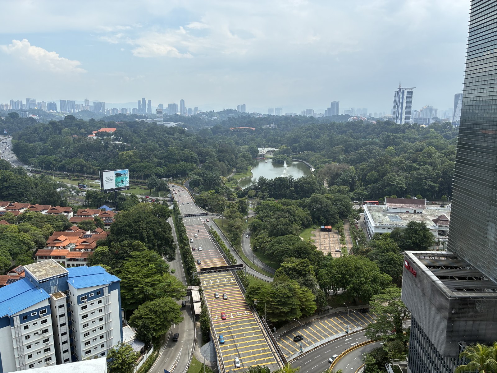View over green parkland, highway and city skyline from a room at Hilton Kuala Lumpur, Malaysia
