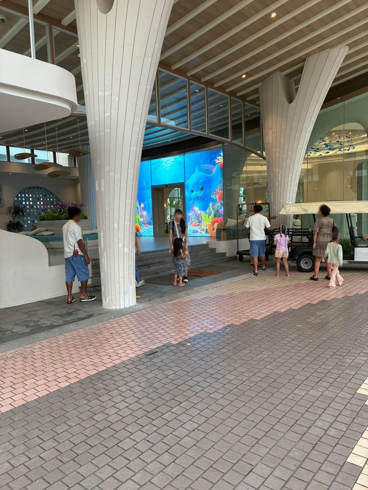 Lobby of Katathani Phuket Beach Resort with a large underwater video wall, Thailand (faces blurred)