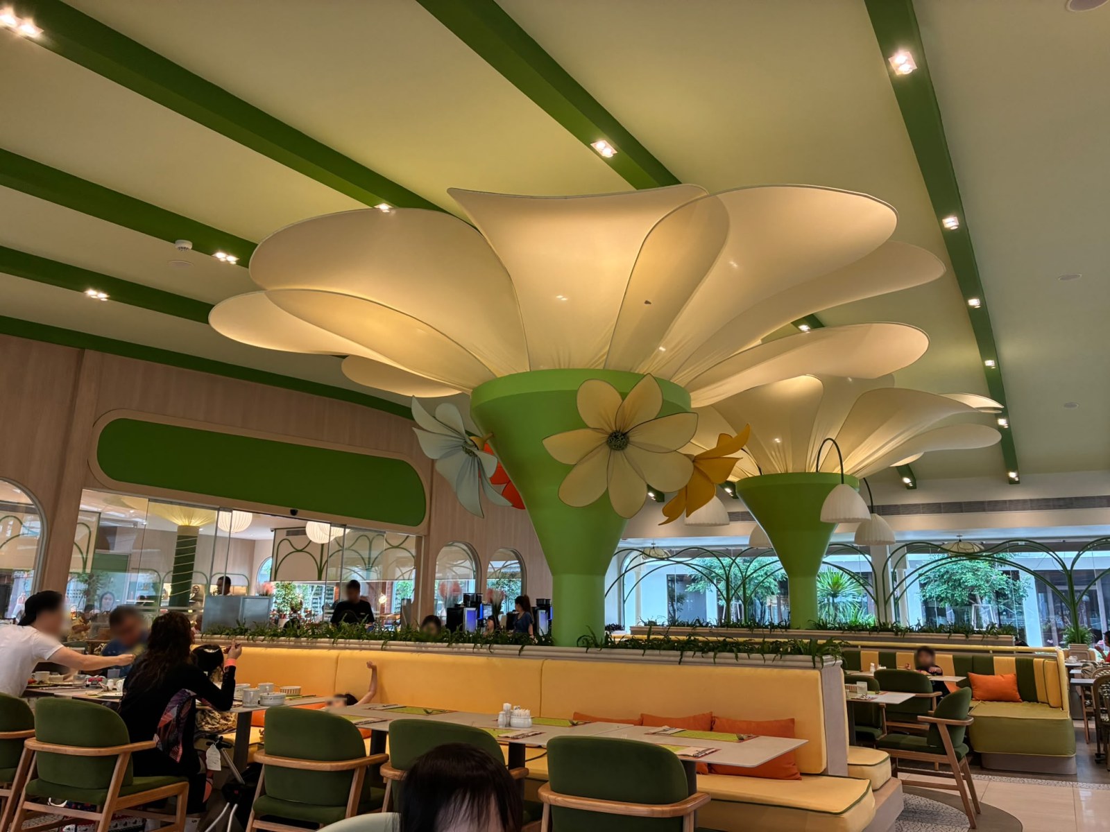 Bright resort restaurant with flower-shaped ceiling canopies at Katathani Phuket Beach Resort, Thailand (faces blurred)