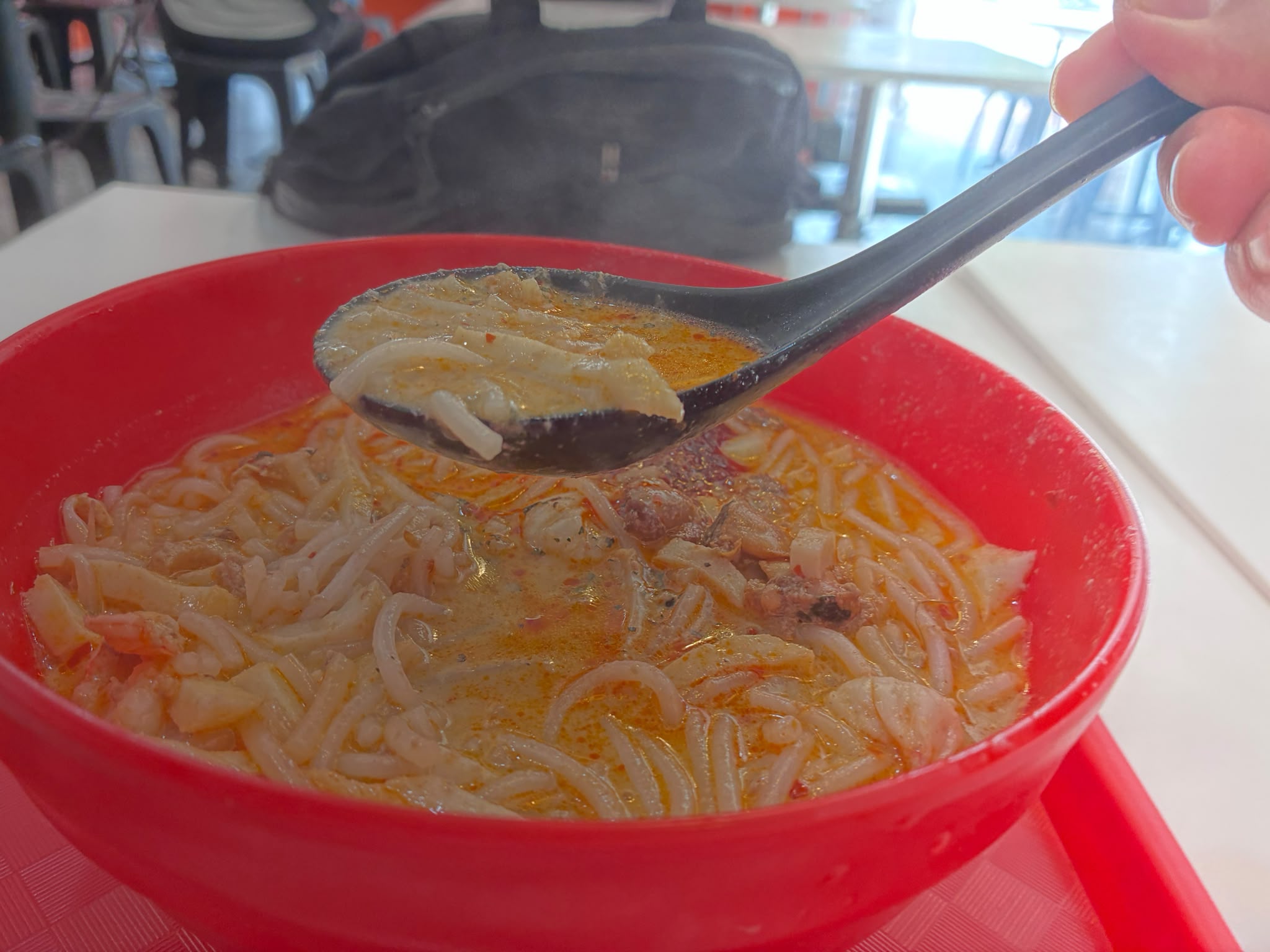 Spoonful of laksa at 328 Katong Laksa, Singapore