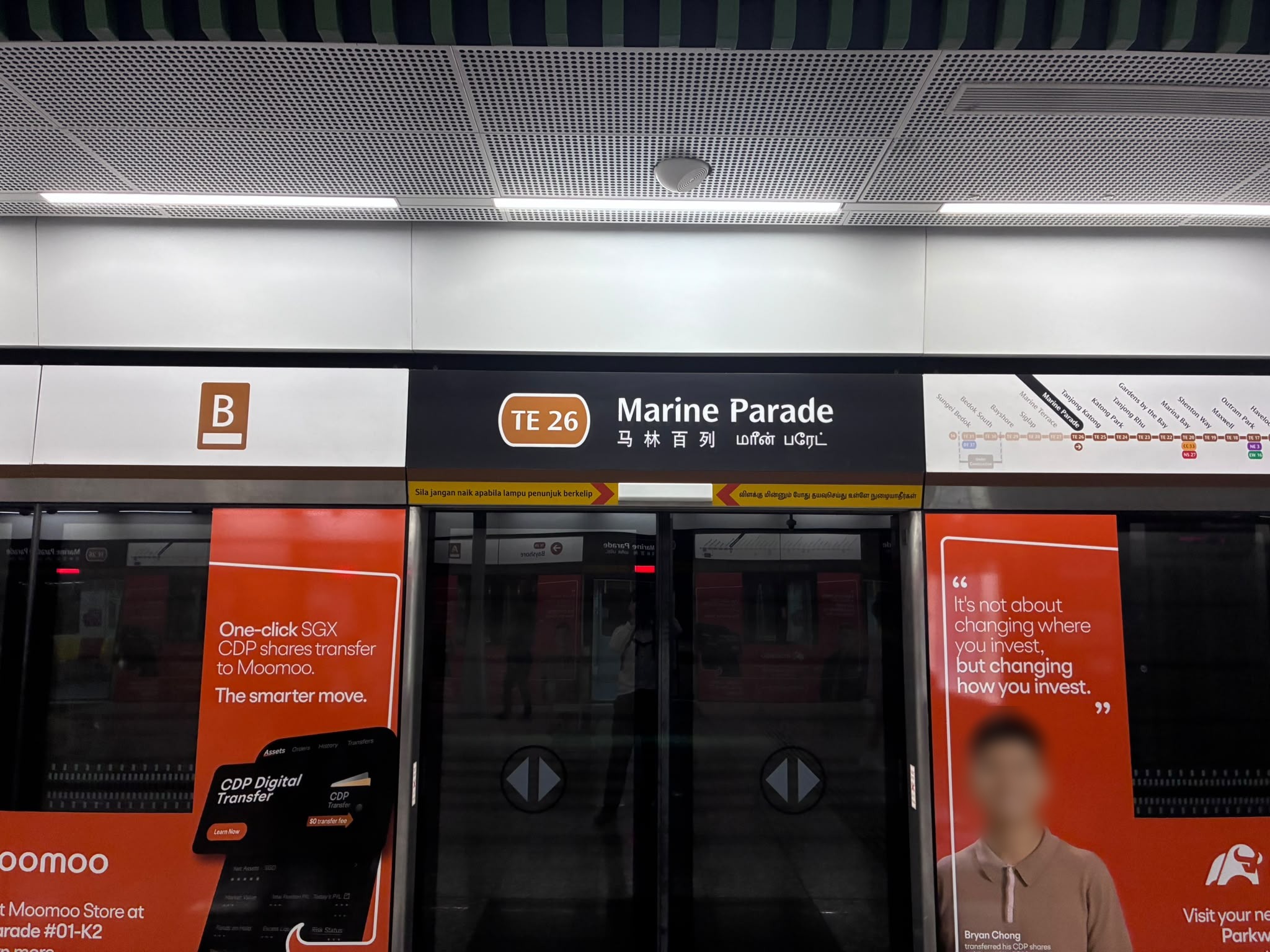 Marine Parade MRT station (TE26) platform sign, Singapore (faces blurred)