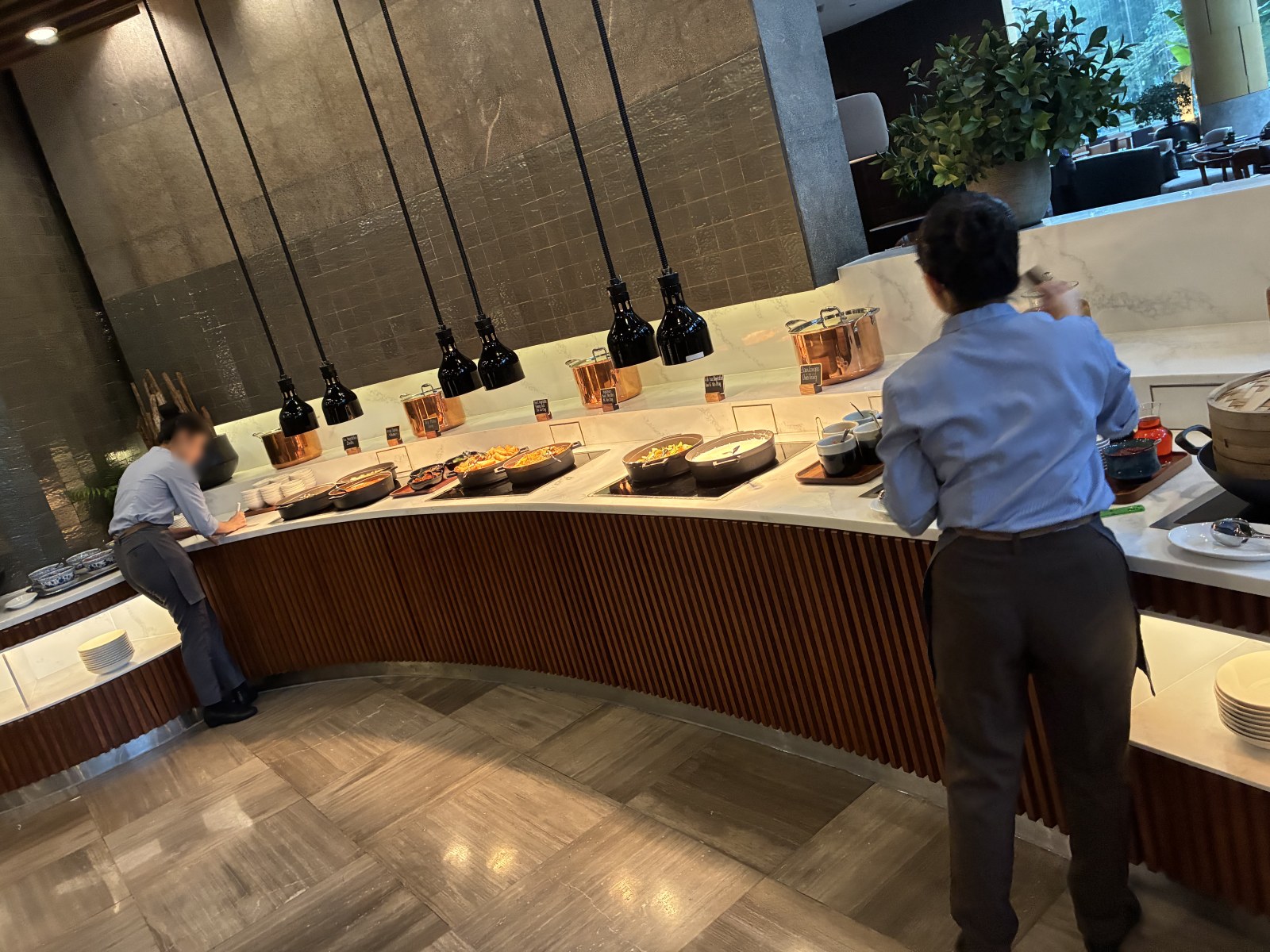 Hot food counter with heat lamps at the New World Saigon Hotel breakfast buffet, Vietnam (faces blurred)