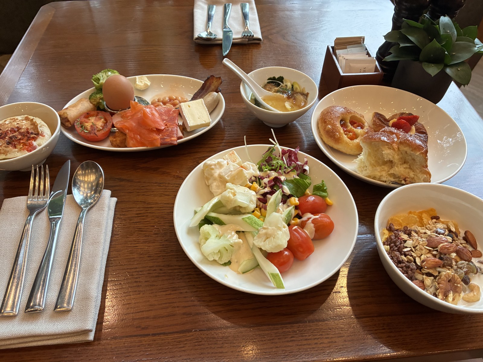 Second breakfast plate with smoked salmon, salad, bread and granola at New World Saigon Hotel, Vietnam
