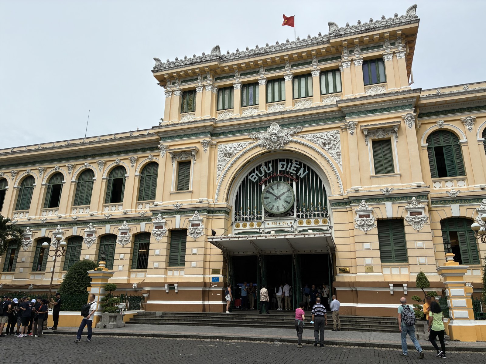 Wide view of the colonial facade of Saigon Central Post Office, Ho Chi Minh City, Vietnam (faces blurred)