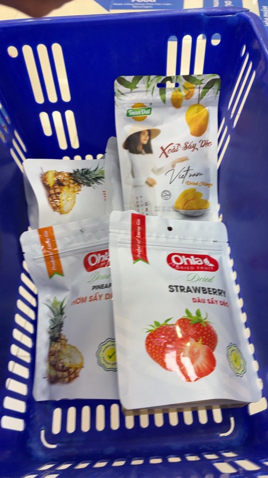 Shopping basket with Vietnamese dried mango, pineapple and strawberry snacks
