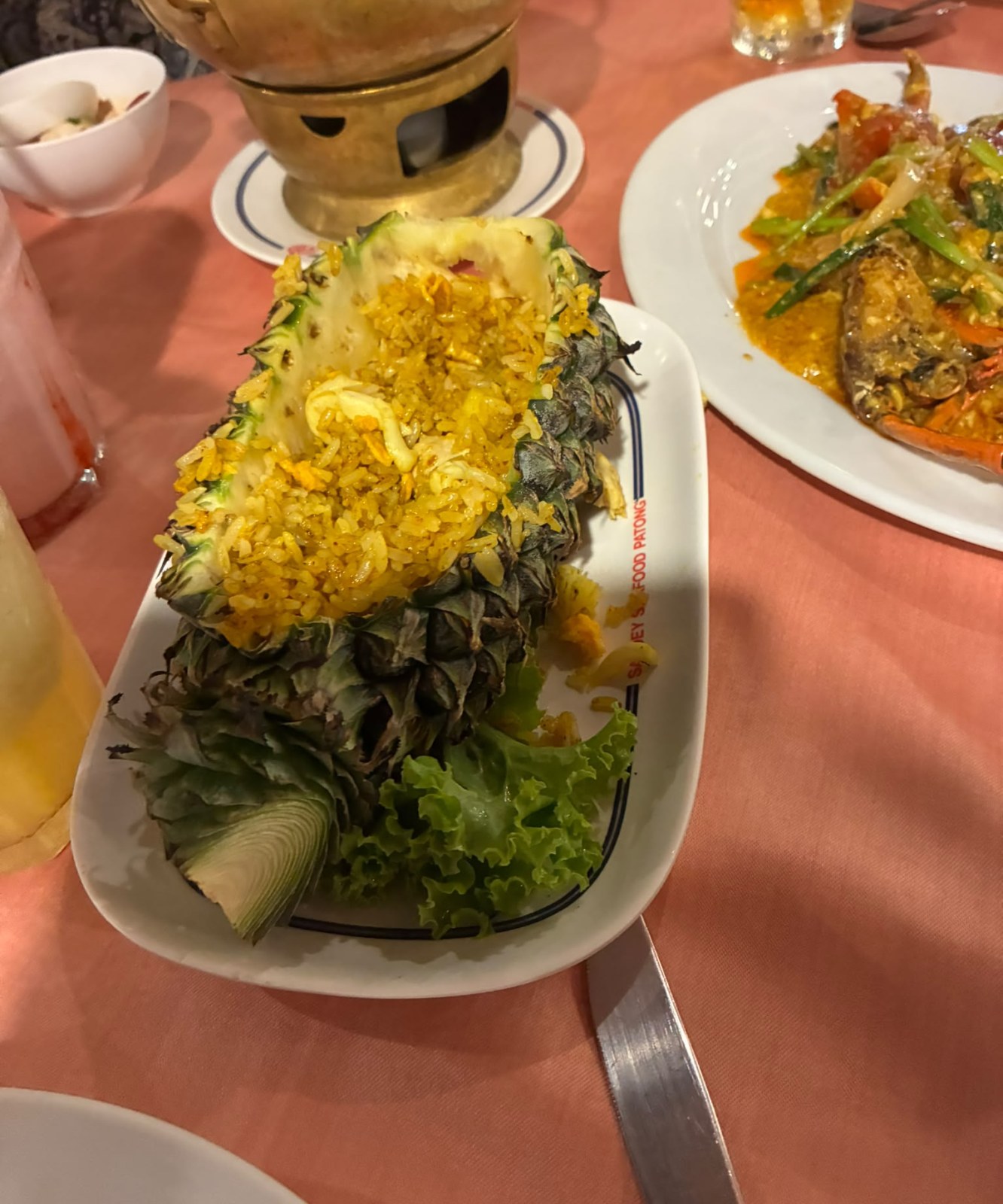 Pineapple fried rice served in a carved pineapple with a tom yum hotpot at Savoey Seafood Patong, Phuket