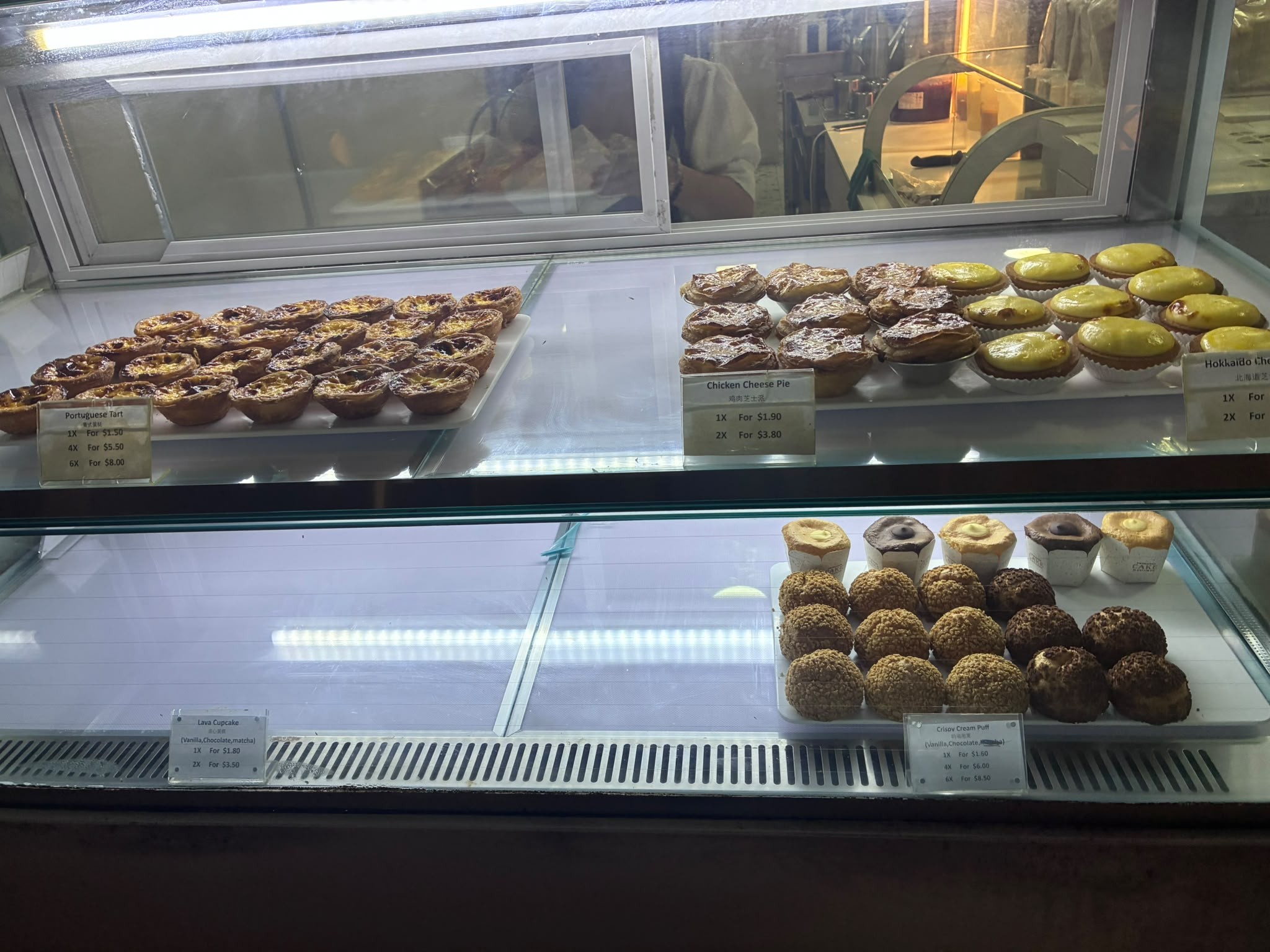 Portuguese egg tarts, chicken cheese pies and cream puffs in the showcase at 50 Years Taste of Tradition