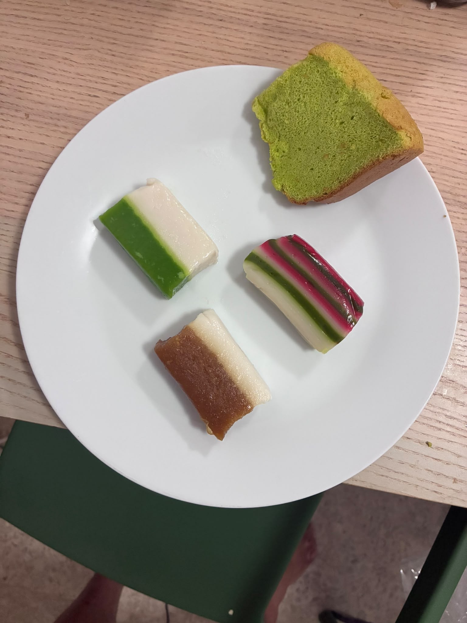 Kueh talam, kueh lapis, talam gula melaka and pandan chiffon cake from Bengawan Solo on a plate
