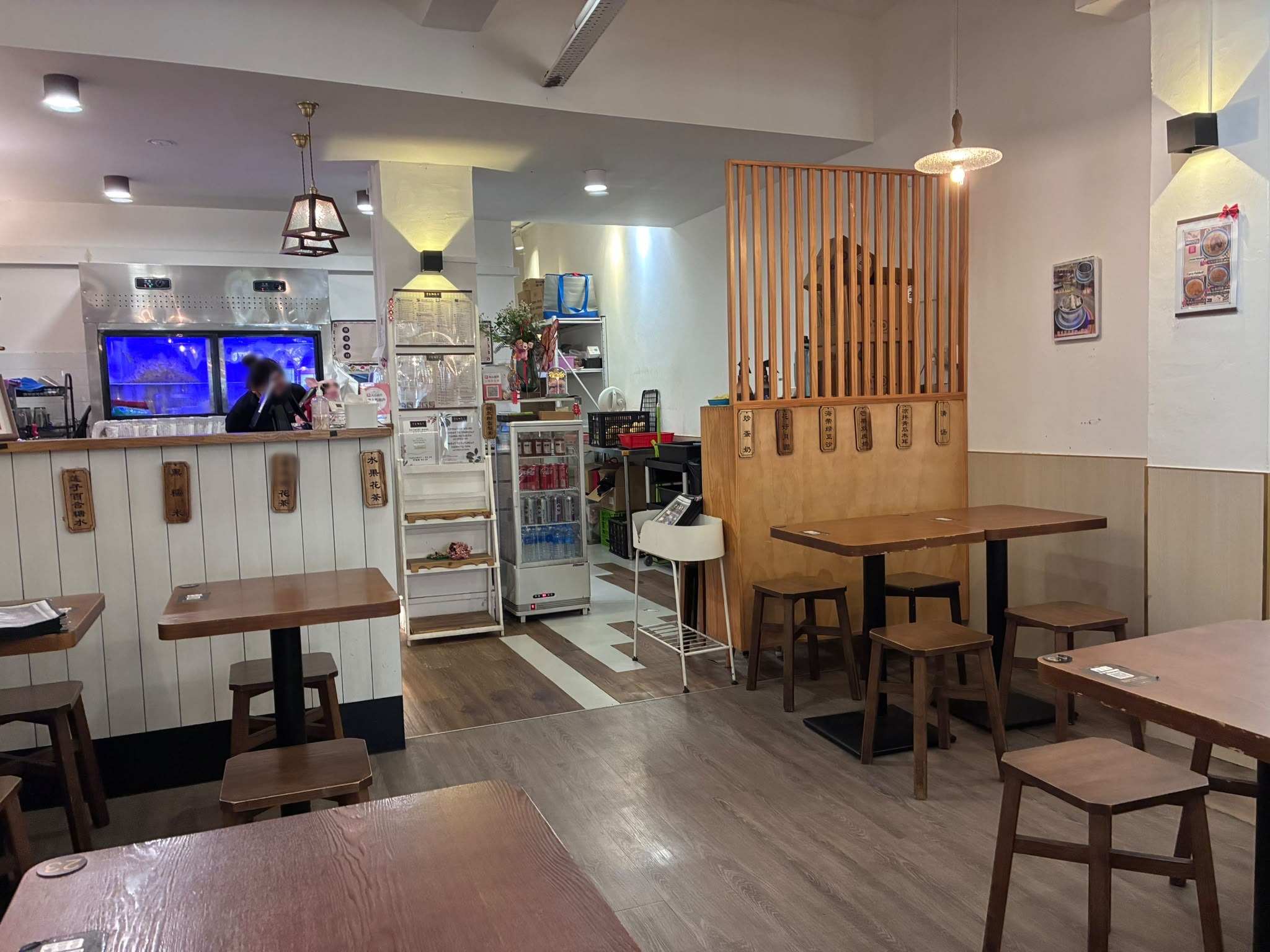 Inside Jin Yu Man Tang Dessert Shop with wooden tables, Singapore (faces blurred)